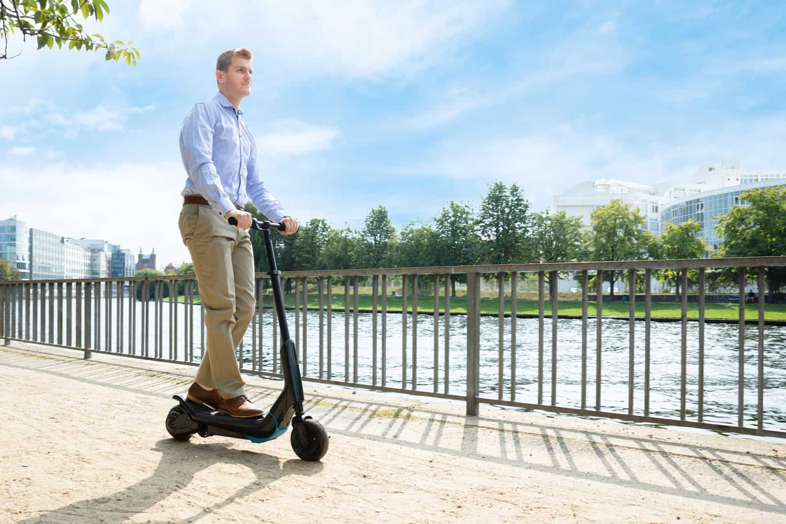 Young Man Riding An Electric Scooter