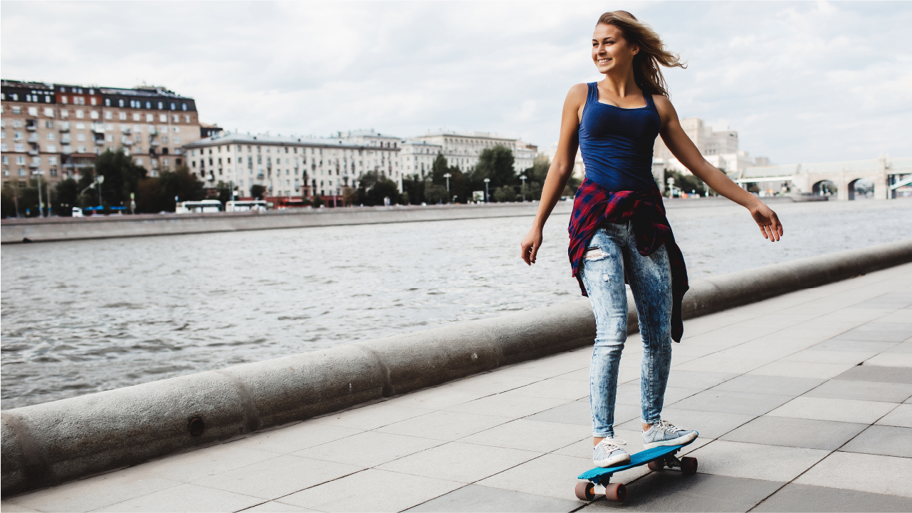 Happy and Beautiful young woman riding electric skateboard